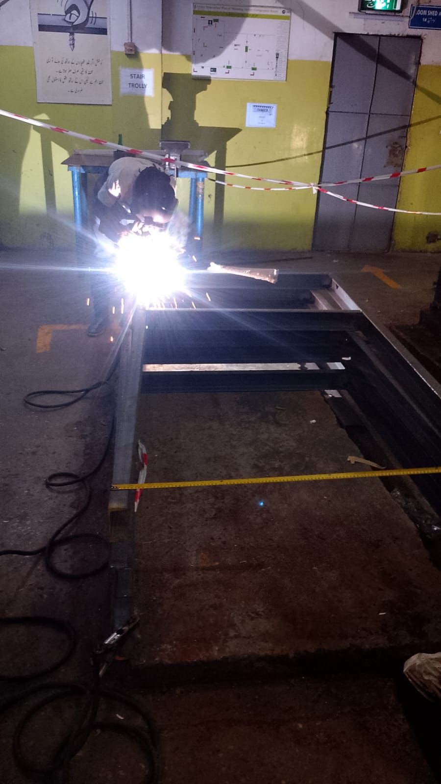 Certified welder fabricating a steel base frame