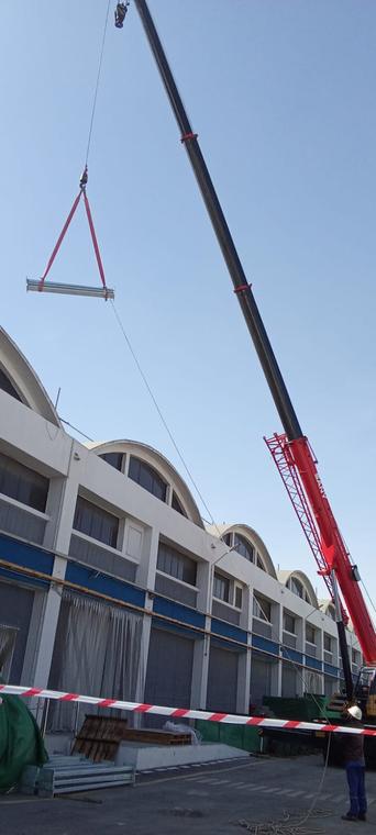 Crane Mobilisation — Barricaded lift zone alongside a running production hall